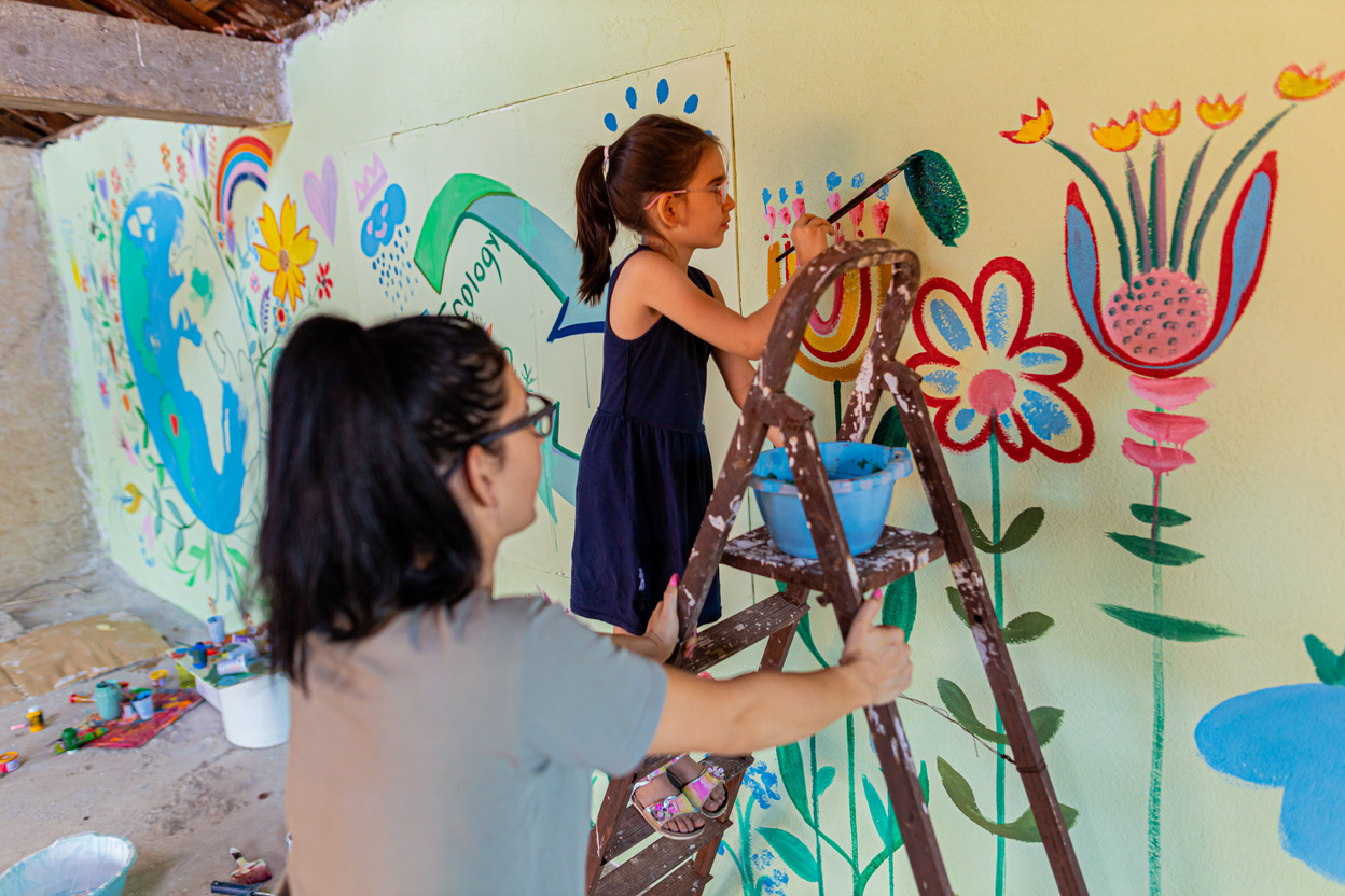 Family creating eco mural